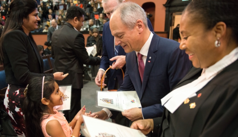 The president shaking a little girl's hand