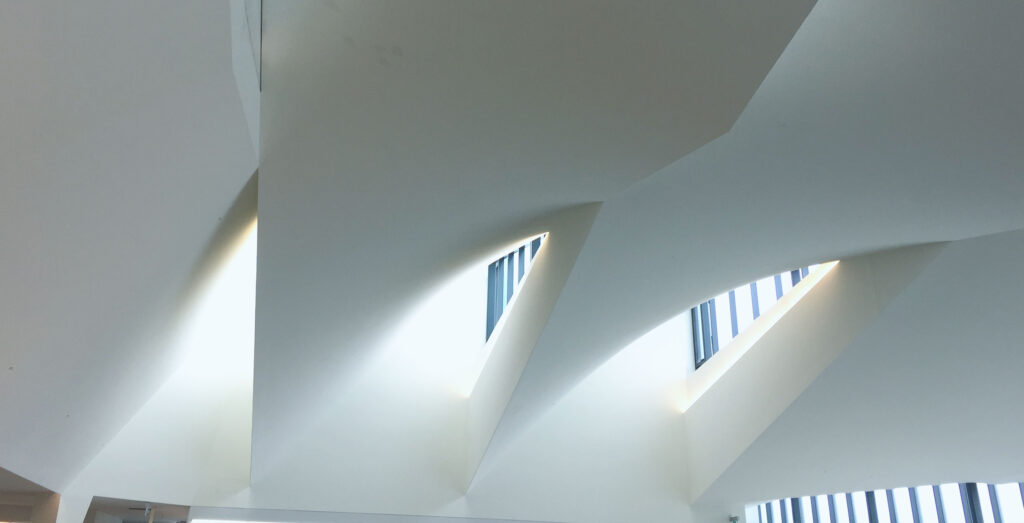 Sunshine floods through a series of skylights hidden in an oddly shaped ceiling.